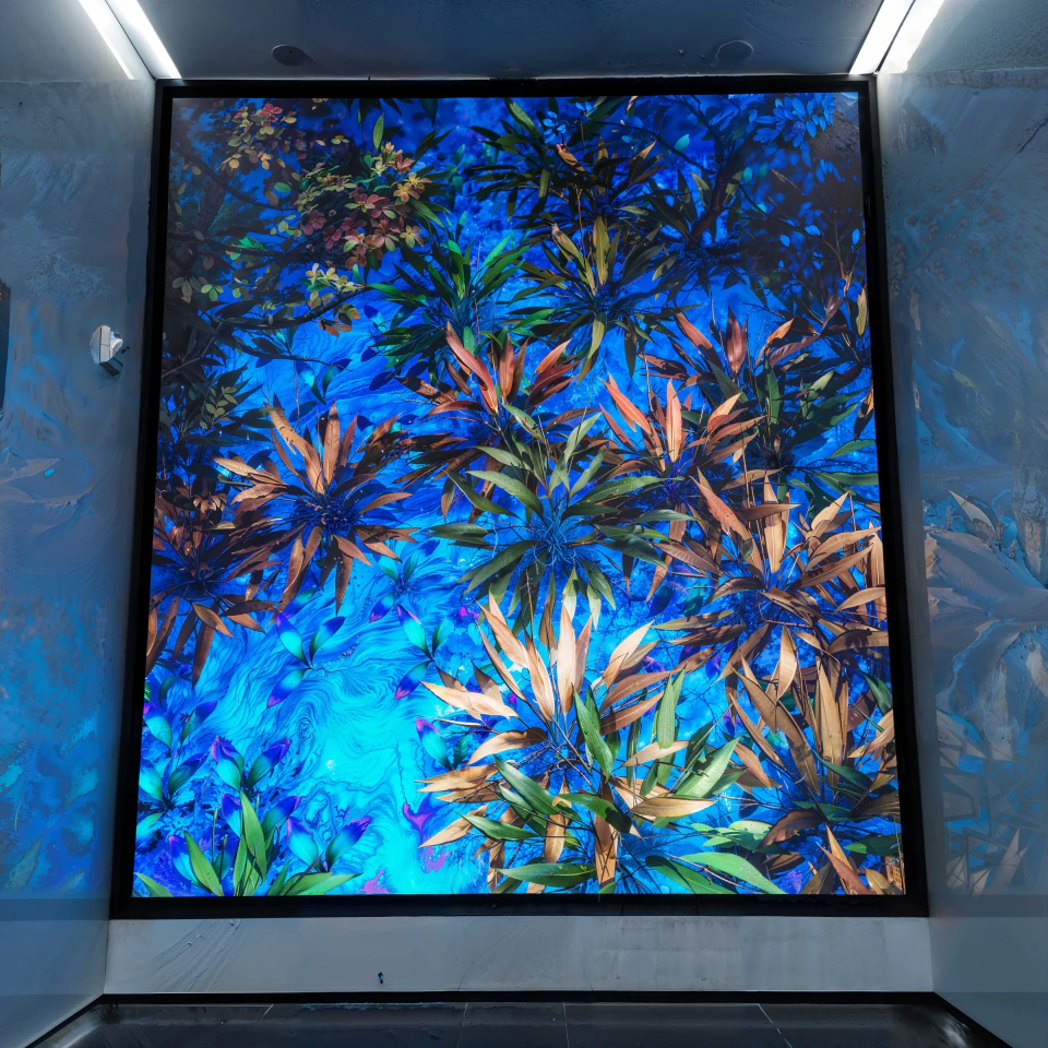 Third Nature — dense synthetic foliage in blues, teals and orange filling the 1275K LED wall