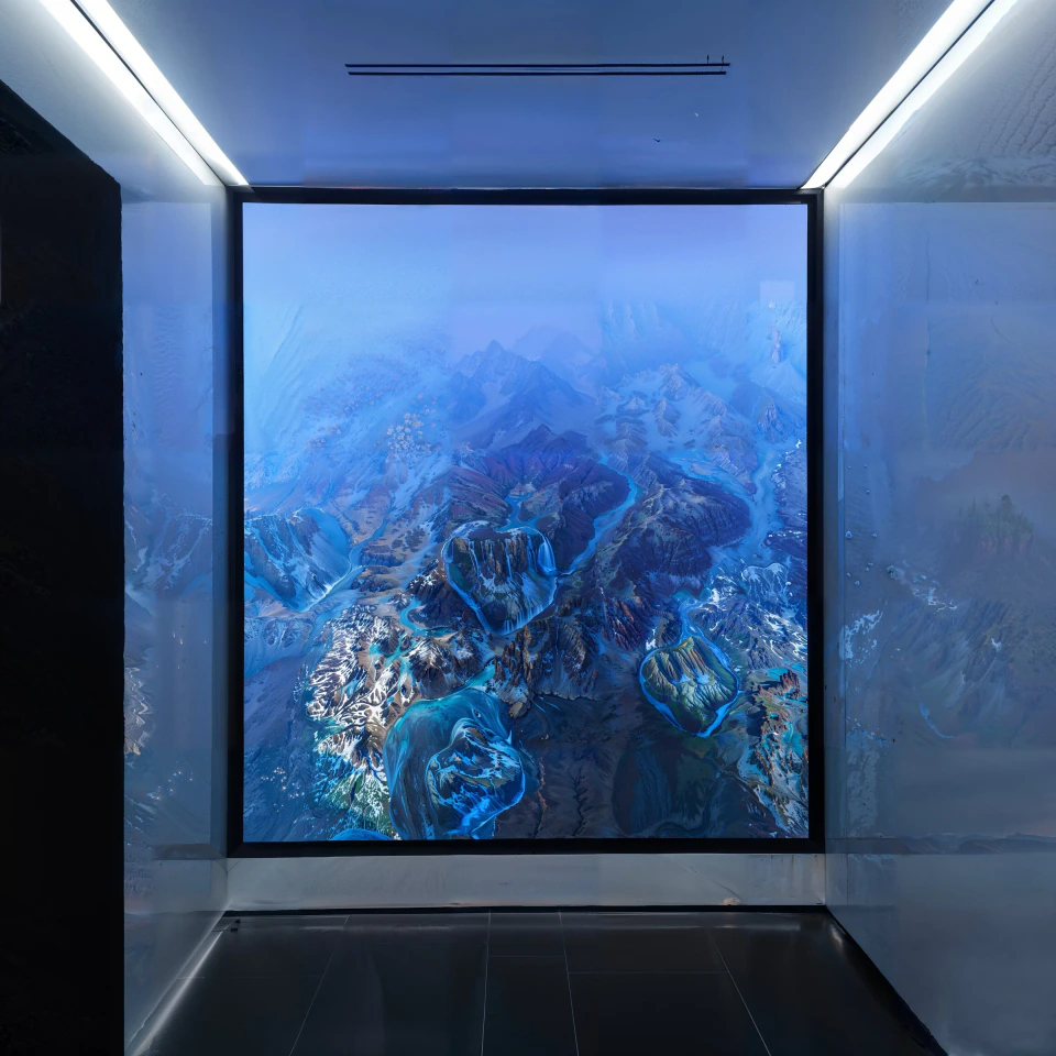 Scape — ice-blue generative terrain on the 1275K LED wall, reflected in the polished lobby floor