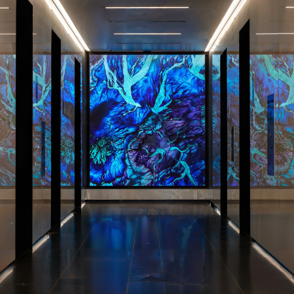 Scape — deep blue generative landscape on the 1275K LED wall, reflected across the dark lobby floor